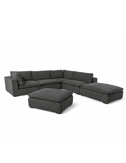 Sala modular gris vista lateral con cojines grandes y diseño contemporáneo