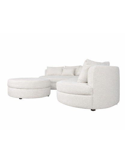 sofá modular curvo blanco vista lateral con chaise y taburete diseño orgánico toura